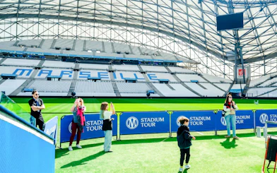Visitors taking photos at OM Stadium in Marseille during a guided tour.