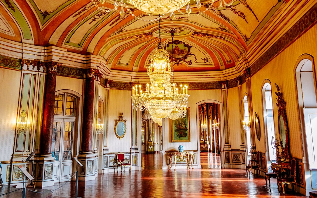 National Palace of Queluz Music Room with ornate chandeliers and decorative ceiling.