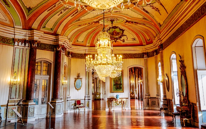 National Palace of Queluz Music Room with ornate chandeliers and decorative ceiling.
