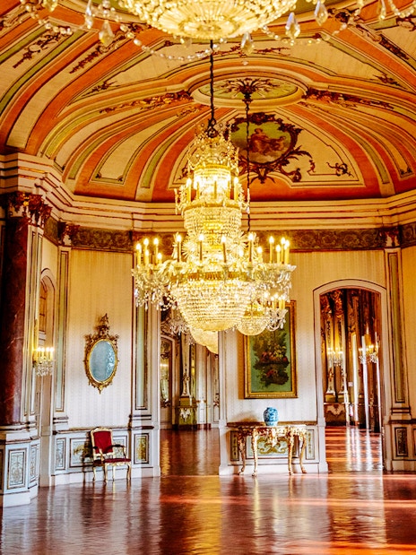 National Palace of Queluz Music Room with ornate chandeliers and decorative ceiling.