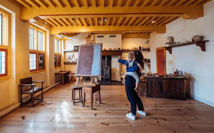 Visitors exploring an art studio at the Rembrandt House Museum, Amsterdam.