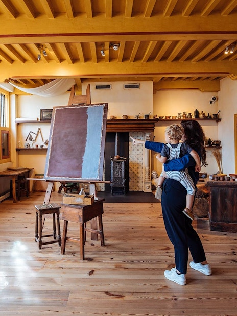 Visitors exploring an art studio at the Rembrandt House Museum, Amsterdam.