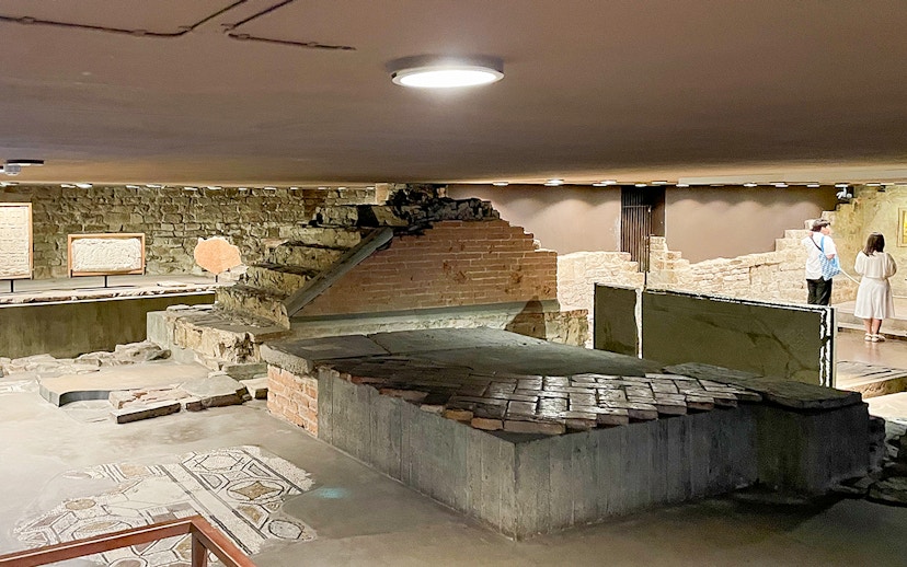 Crypt of Santa Reparata in Florence with ancient stone steps and mosaic floor.