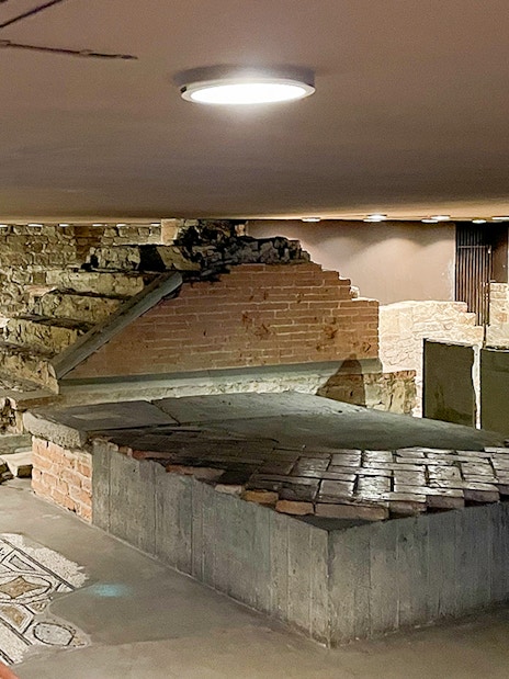 Crypt of Santa Reparata in Florence with ancient stone steps and mosaic floor.