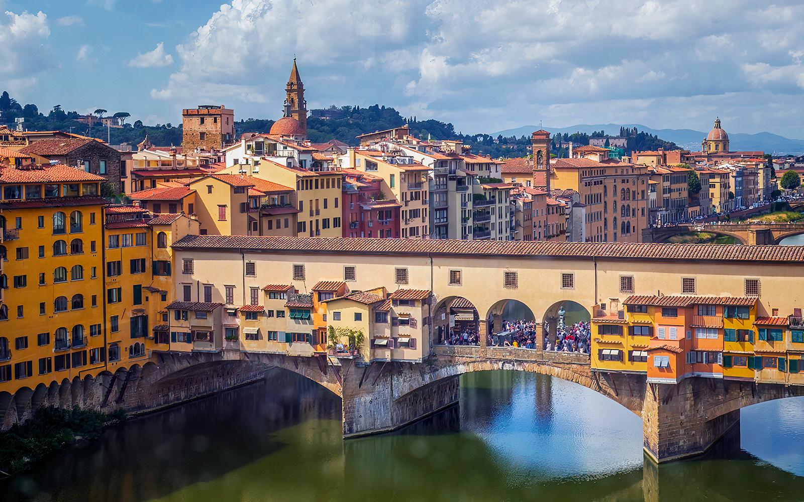 Ponte Vecchio bridge over the Arno River in Florence, Italy, seen on a day tour from Milan.