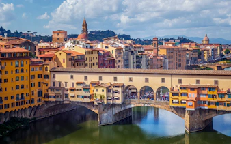 Ponte Vecchio bridge over the Arno River in Florence, Italy, seen on a day tour from Milan.