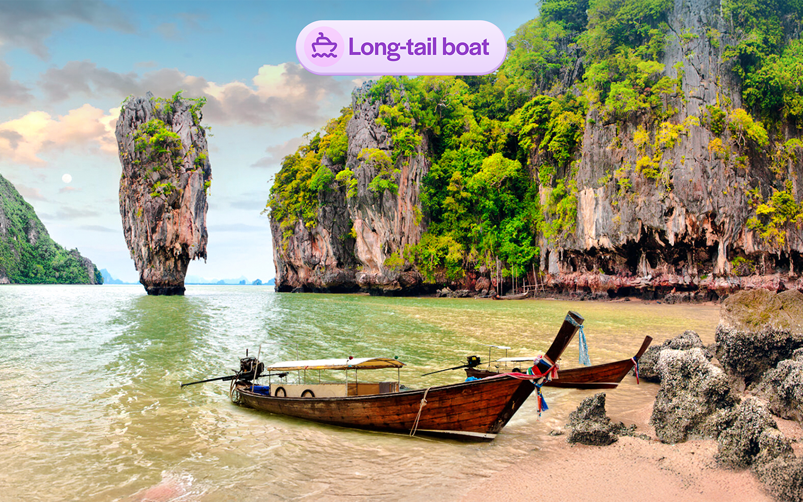 Long-tail boat near limestone cliffs at James Bond Island, Thailand.