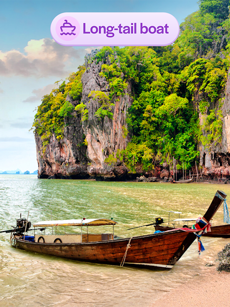 Long-tail boat near limestone cliffs at James Bond Island, Thailand.