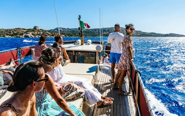 Tourists enjoying a motorboat tour of the La Maddalena Archipelago, Italy.