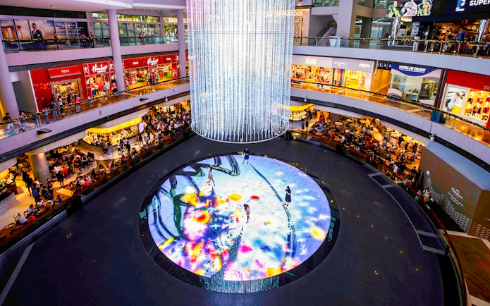 Visitors interacting with digital art display at Digital Light Canvas, Marina Bay Sands, Singapore.