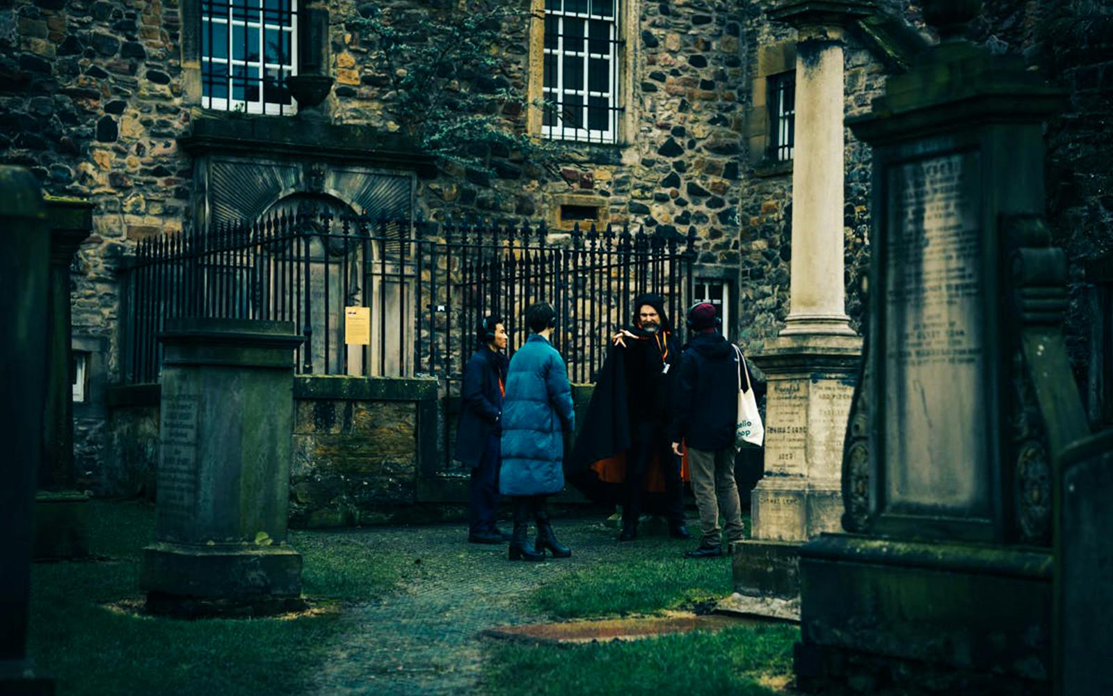 Guests on a guided tour in a historic Edinburgh graveyard.
