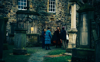 Guests on a guided tour in a historic Edinburgh graveyard.