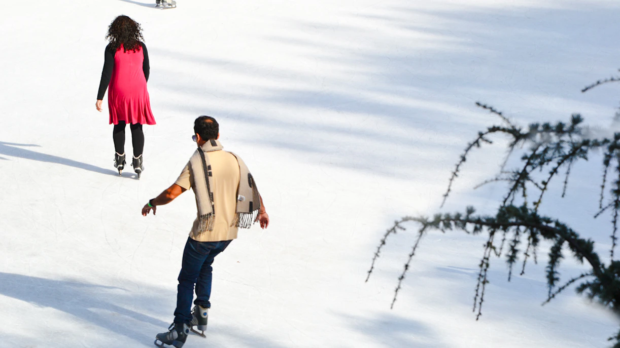 People ice skating at Wollman Rink in Central Park, New York City.