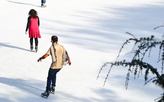 People ice skating at Wollman Rink in Central Park, New York City.
