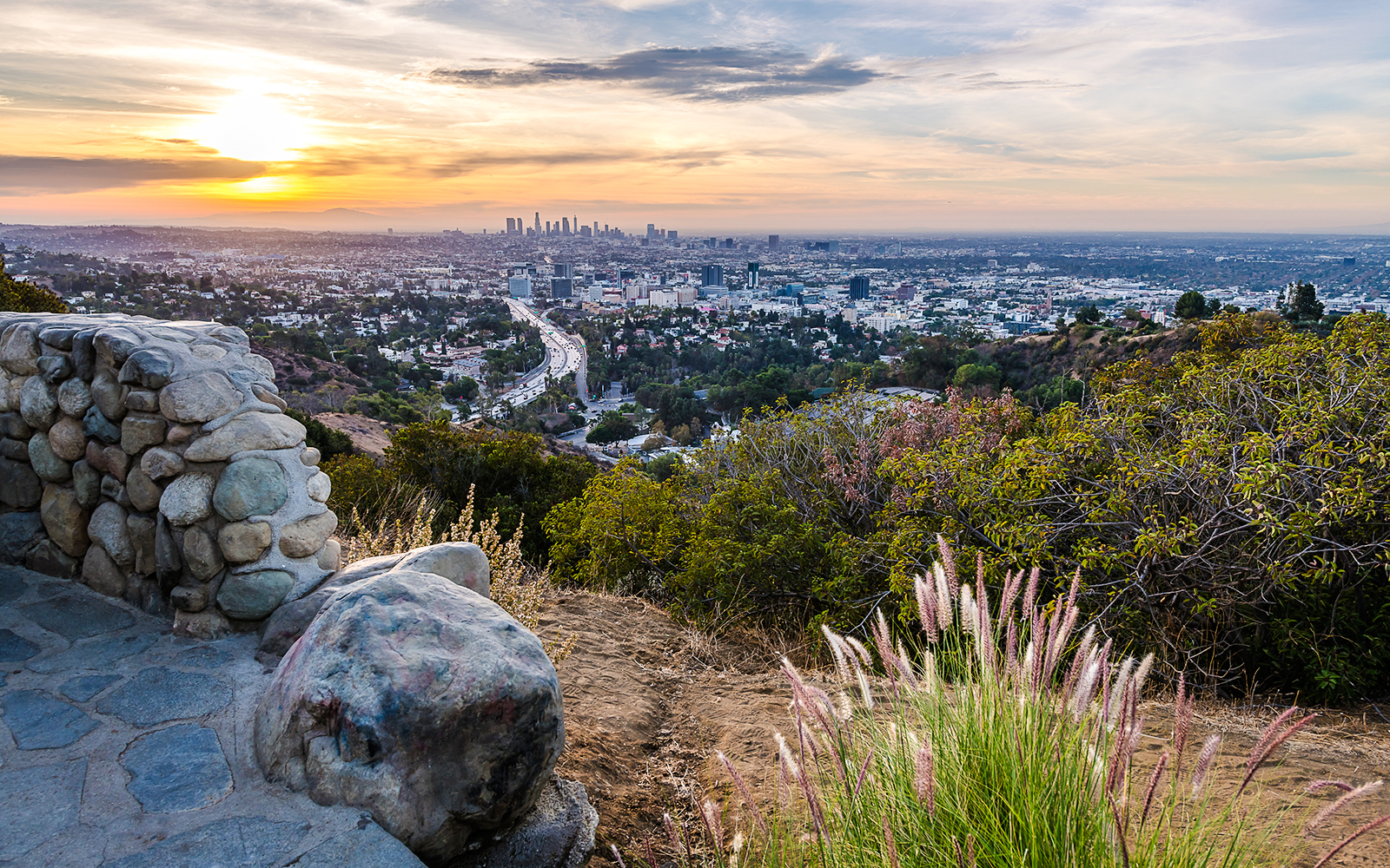 Overlooking Los Angeles skyline from Hollywood Bowl Overlook, California at sunset.