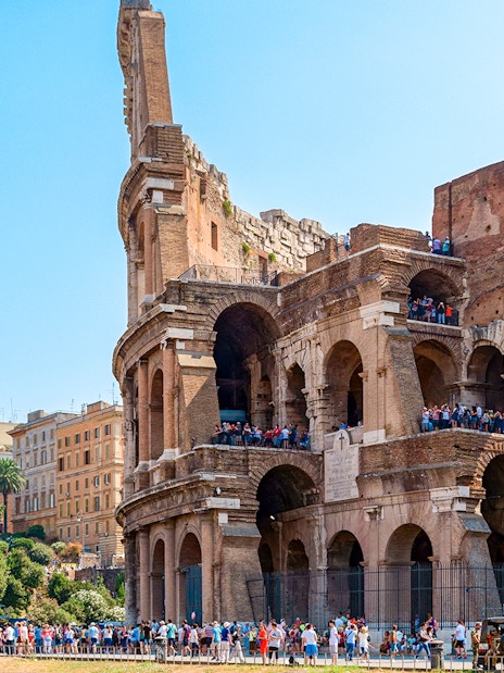 Colosseum in Rome with tourists on an express guided tour.