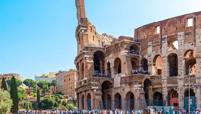 Colosseum in Rome with tourists on an express guided tour.