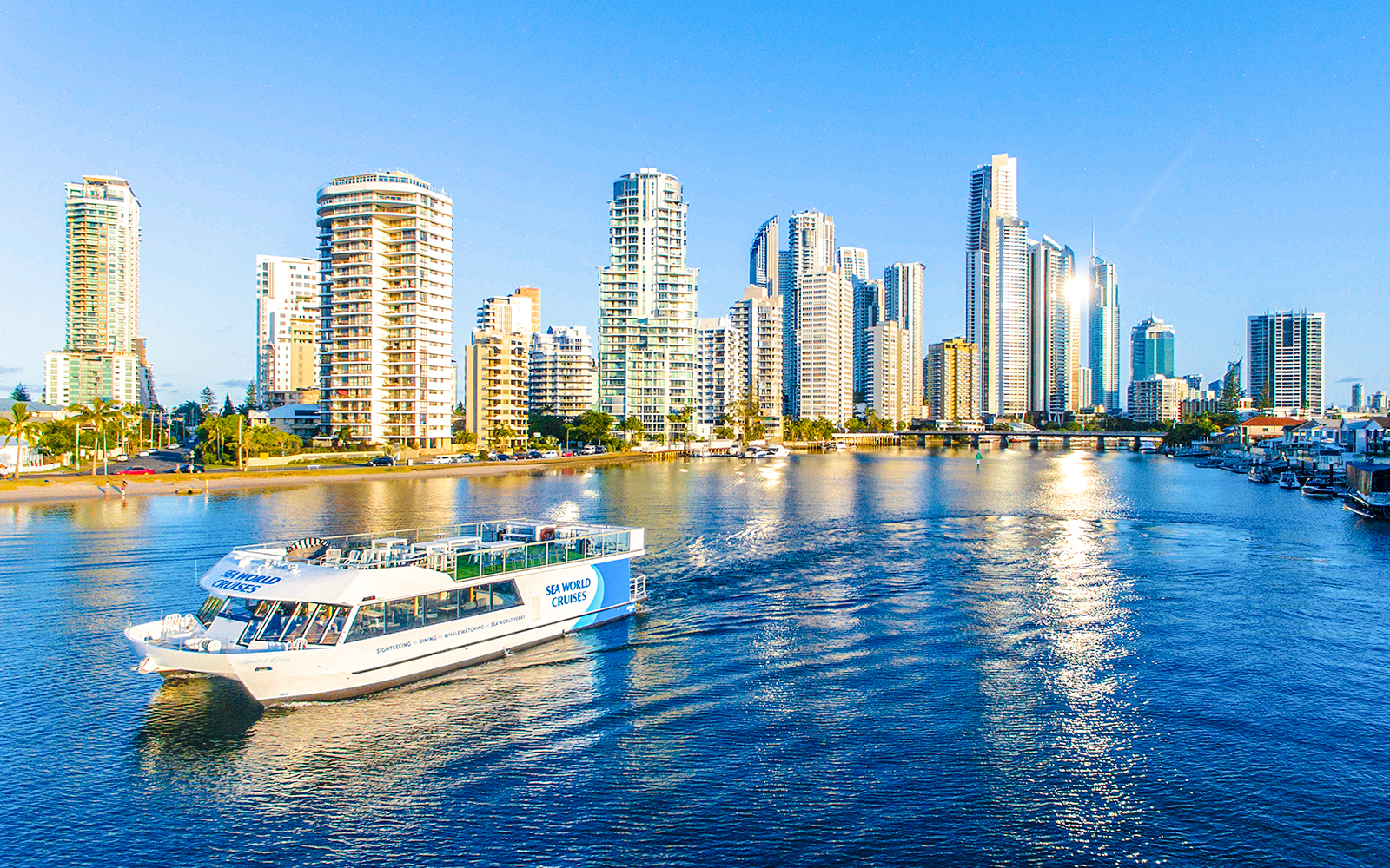 Spirit of Elston vessel cruising Gold Coast waters with city skyline in background.