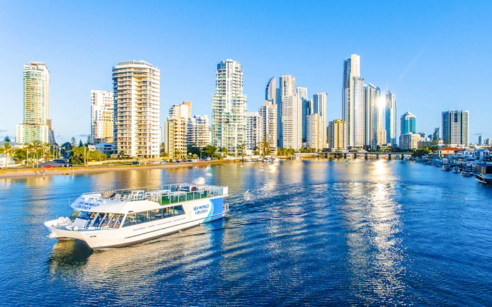 Spirit of Elston vessel cruising Gold Coast waters with city skyline in background.