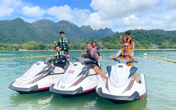 Jet skiing at Paradise 101, Langkawi with lush mountains in the background.