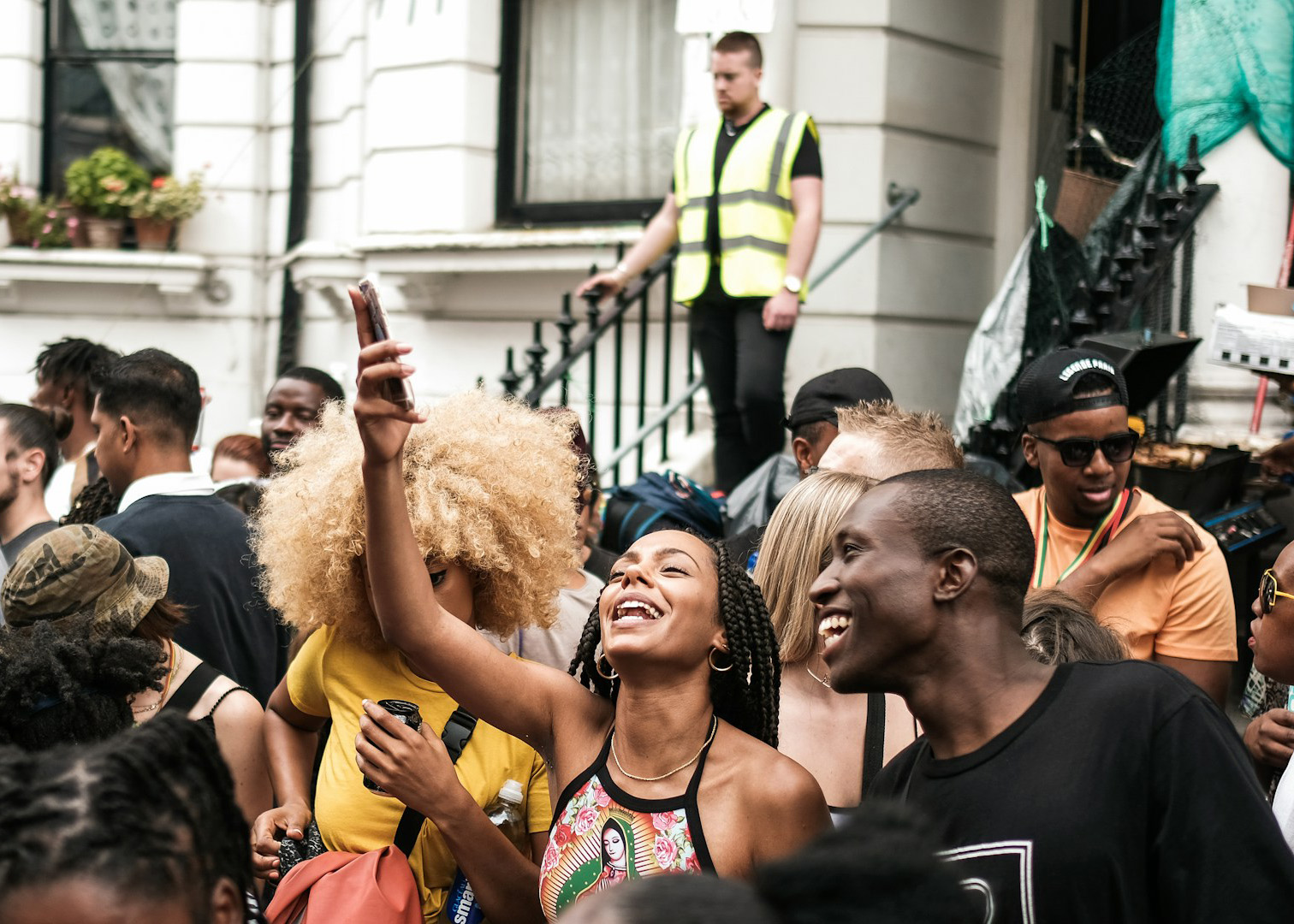 Crowd enjoying the Parade, people smiling and taking photos.