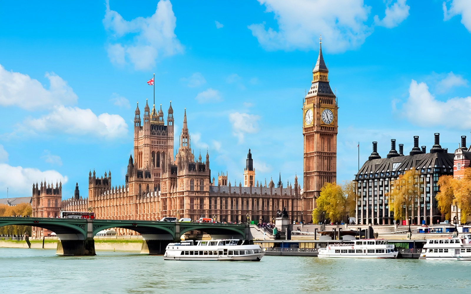 Passengers enjoying a Thames River Sightseeing Cruise, with a view of the iconic London skyline from Westminster to the Tower Bridge