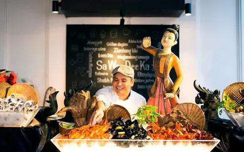 Buffet dinner with seafood and Thai cultural statue at Sala Lakorn, Bangkok.