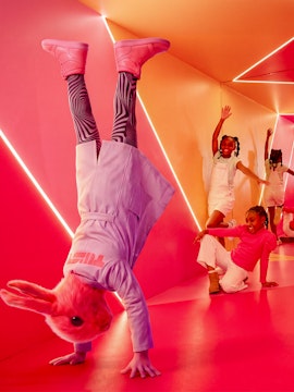 Guests interacting with colorful installations at the Twist Museum in London.