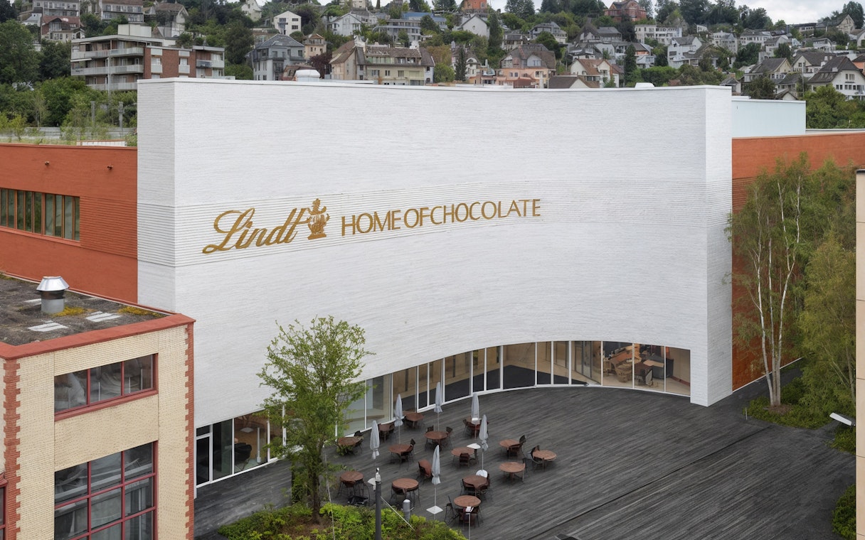 Lindt Home of Chocolate Museum exterior with outdoor seating area.