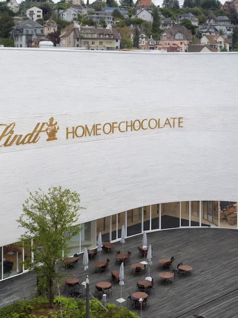 Lindt Home of Chocolate Museum exterior with outdoor seating area.