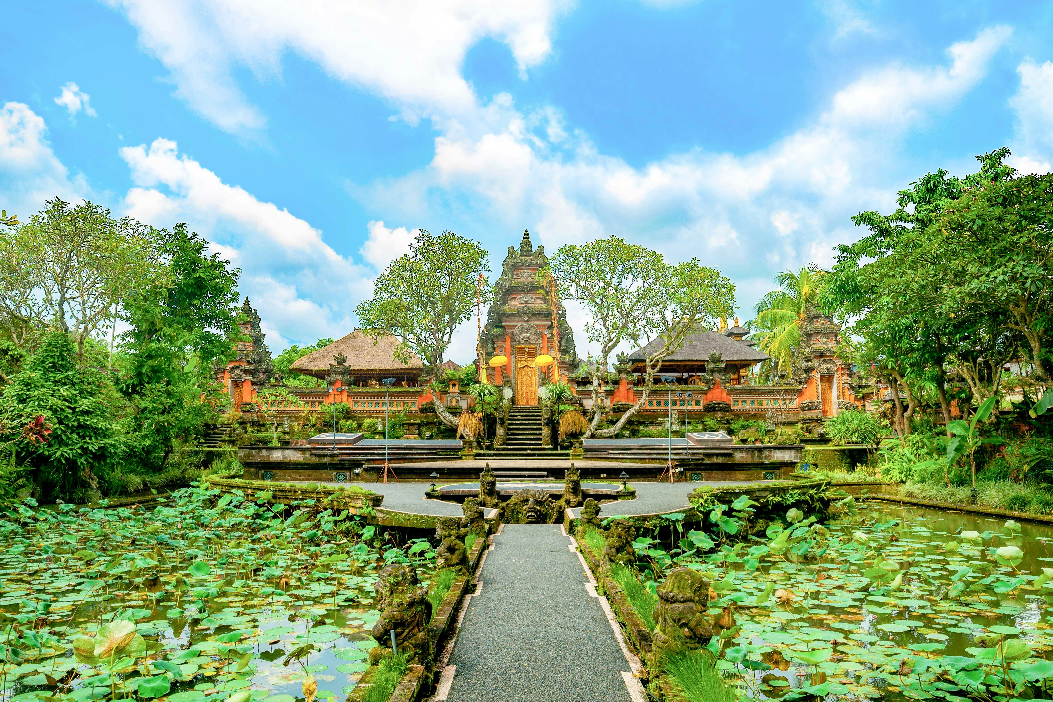 Ubud temple with lotus pond and traditional Balinese architecture.
