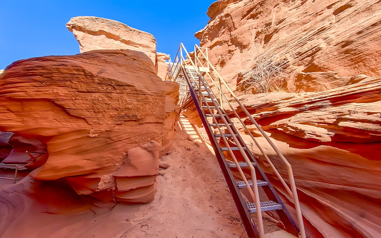 Staircase leading through red rock formations in Antelope Canyon.