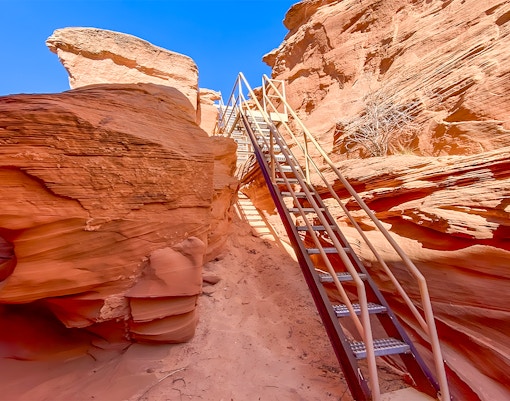 Staircase leading through red rock formations in Antelope Canyon.