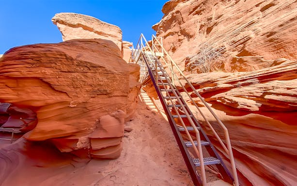Staircase leading through red rock formations in Antelope Canyon.