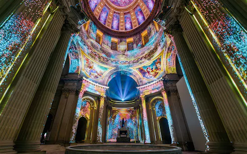 Immersive light display inside Invalides dome, Paris, showcasing vibrant projections.