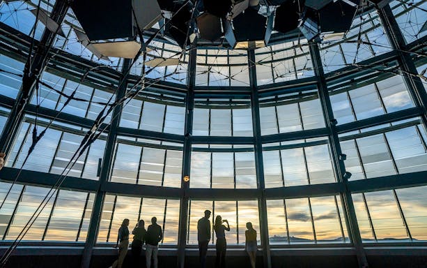 People enjoying the view from Mirador Torre Glòries, Barcelona at sunset.