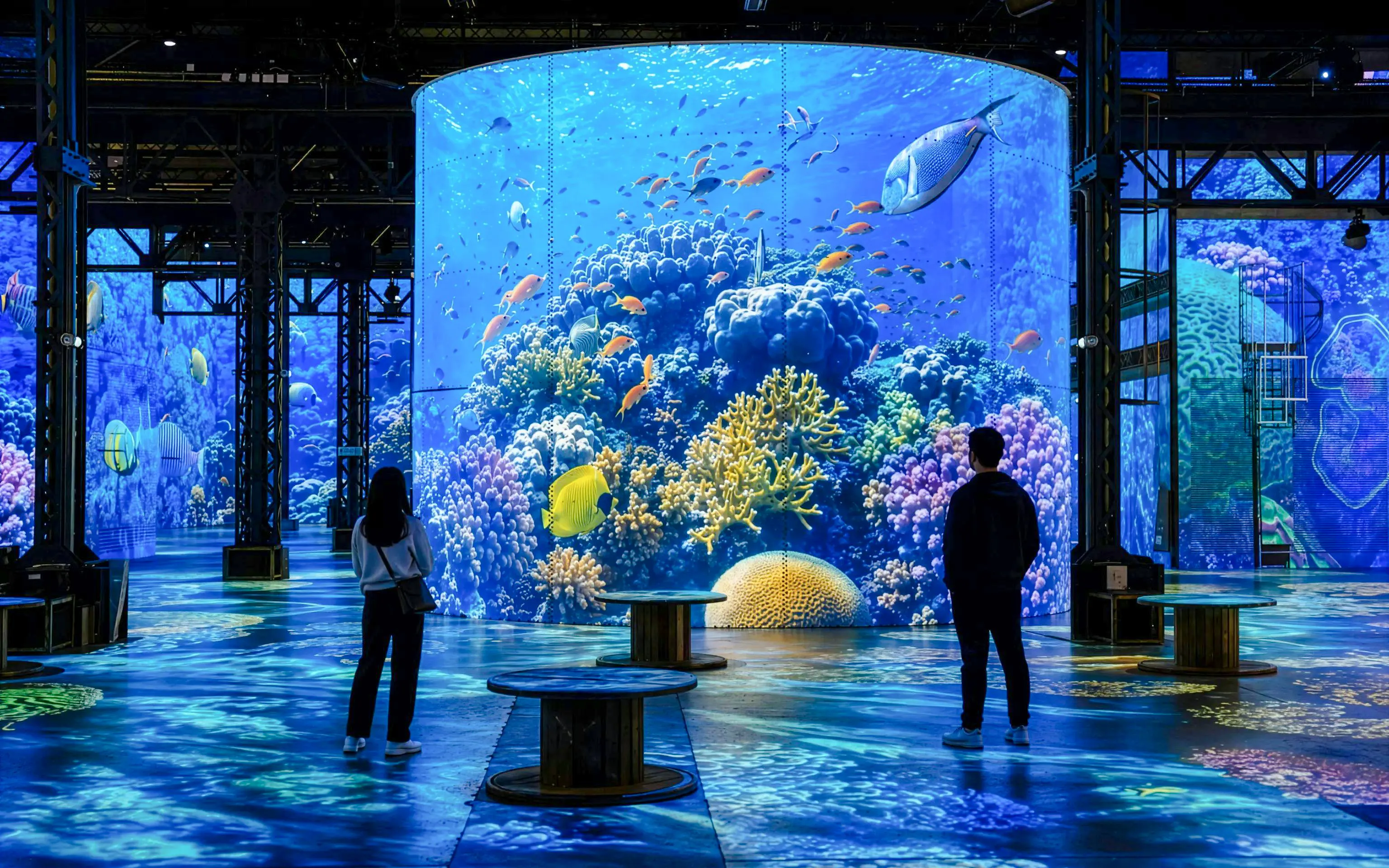 Atelier des Lumières Planète Océan exhibition with digital ocean scenes and visitors.