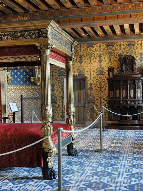 Ornate bedroom with canopy bed in Château de Blois, France.
