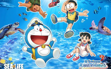 Doraemon characters exploring underwater at SEA LIFE Bangkok with marine animals.
