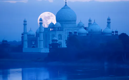 Taj Mahal under full moon viewed from Yamuna River, Agra.