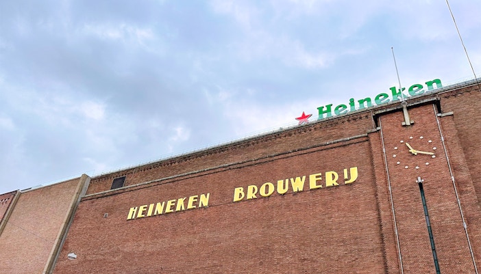 Heineken Experience tour visitors exploring interactive beer brewing exhibits in Amsterdam.