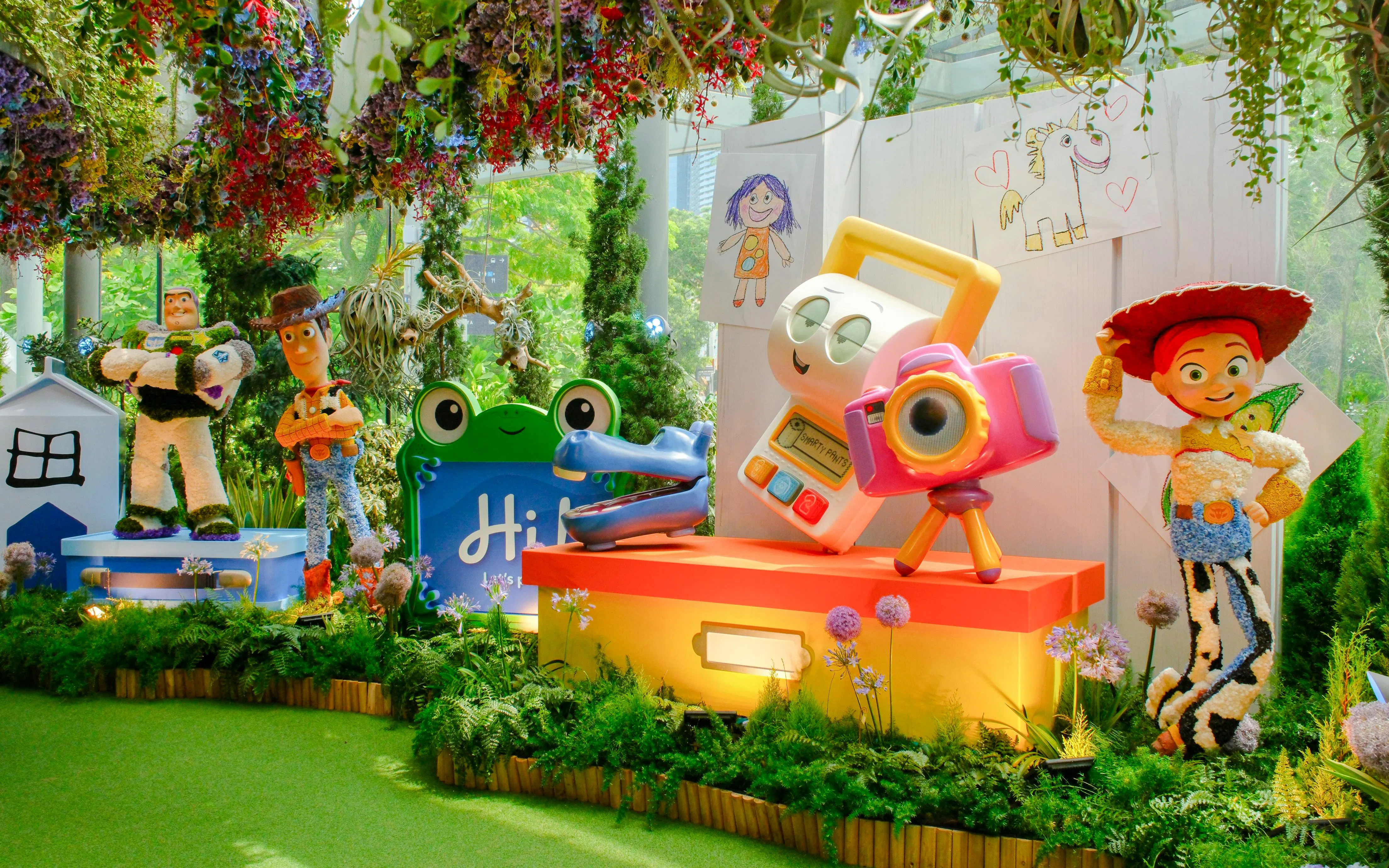 Disney Garden of Wonder with Toy Story characters in a vibrant floral setting.