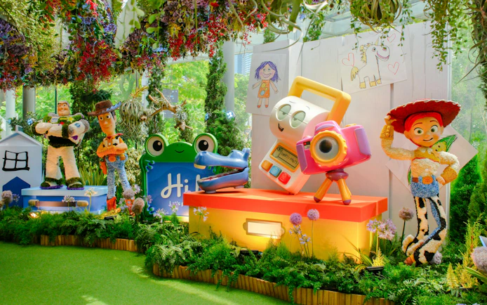 Disney Garden of Wonder with Toy Story characters in a vibrant floral setting.