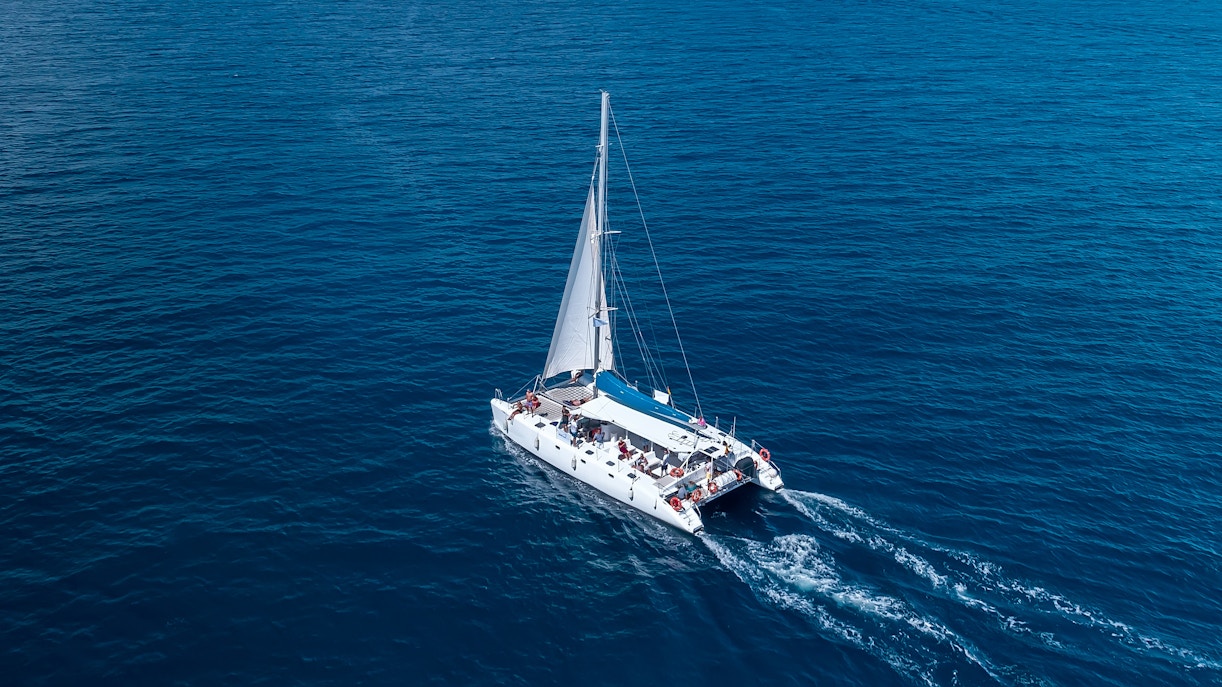 Valencia catamaran cruise with tourists enjoying the Mediterranean Sea.