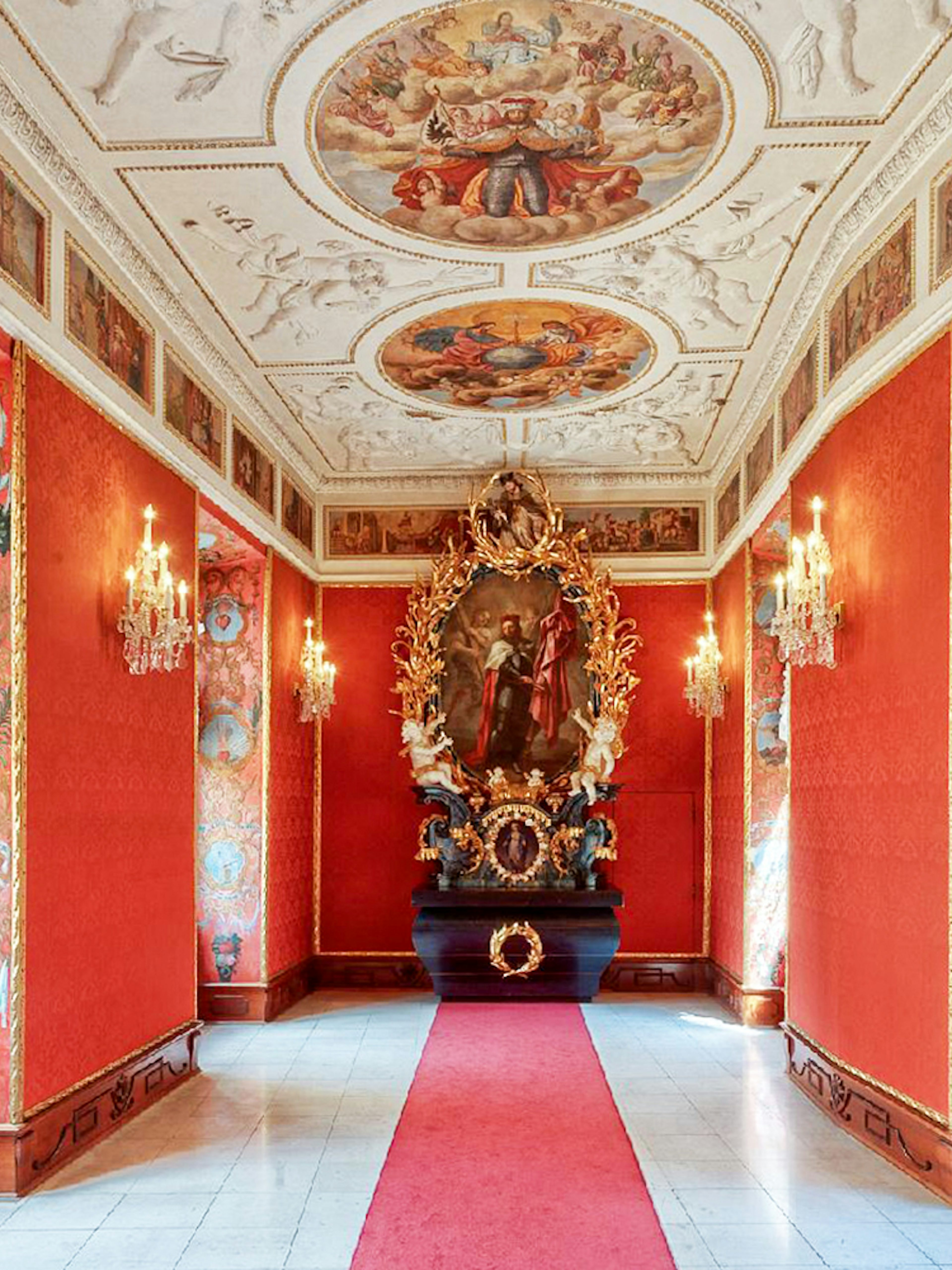 Lobkowicz Palace Museum interior with ornate red walls and historical paintings, Prague audio guide tour.