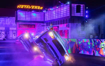 Car performing a stunt on two wheels at Global Village stunt show.