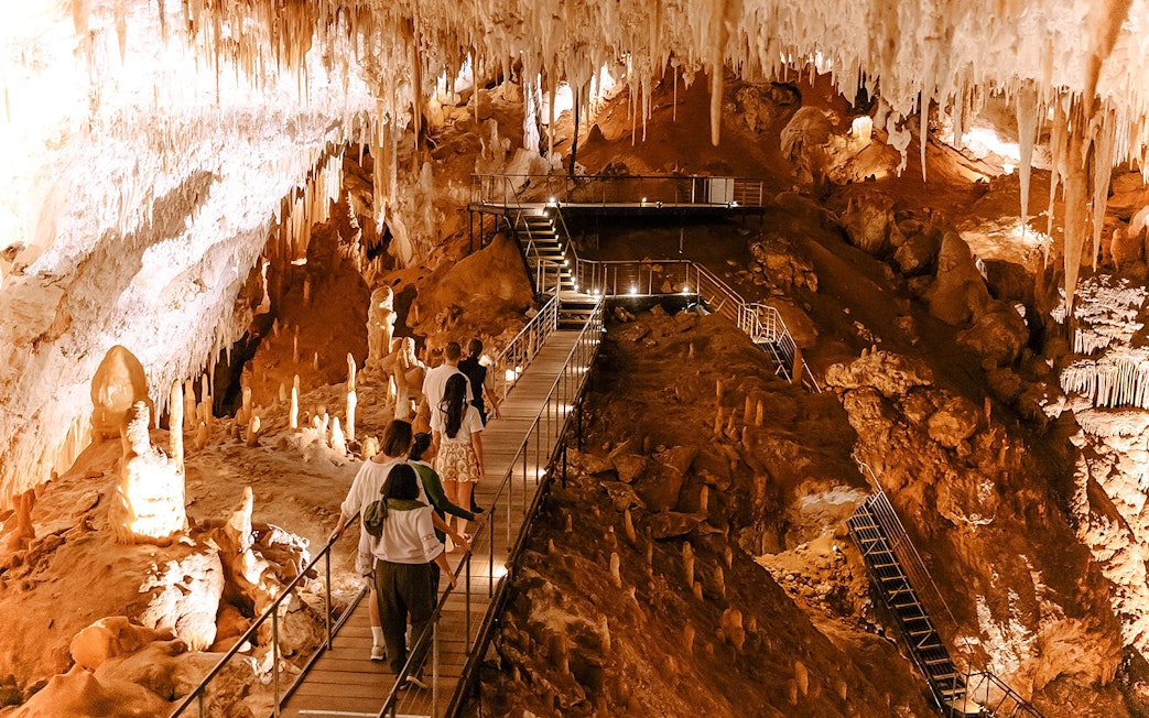 Visitors exploring stalactites and stalagmites in Jewel Cave, Margaret River guided tour.