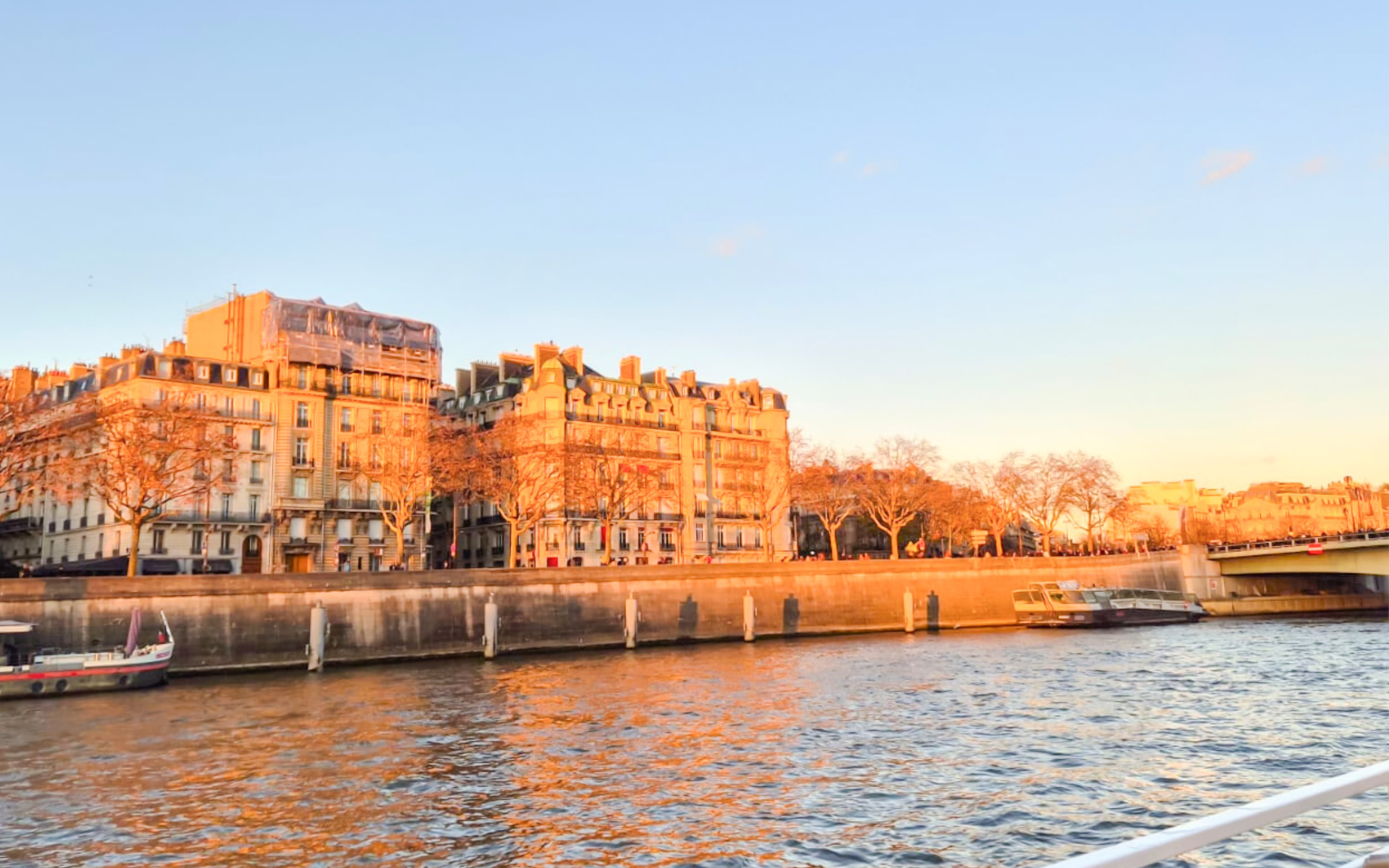 Seine River cruise view with historic buildings in Paris, France.