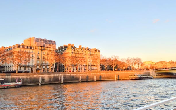 Seine River cruise view with historic buildings in Paris, France.