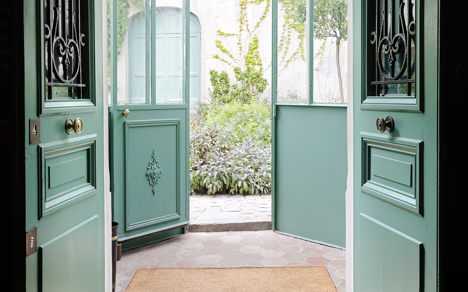 Open doors leading to a garden courtyard at Maison de Balzac, Paris.